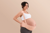 Side view of a pregnant woman wearing the oyster pink Momcozy maternity belly band with shoulder straps.