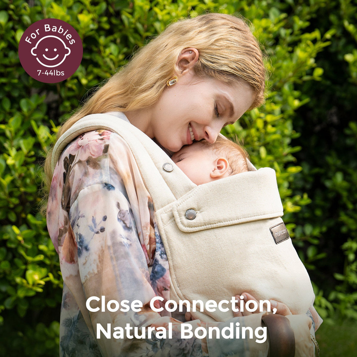 Momcozy baby carrier, beige, for newborns 7-44lbs. Promotes close connection and natural bonding with baby.