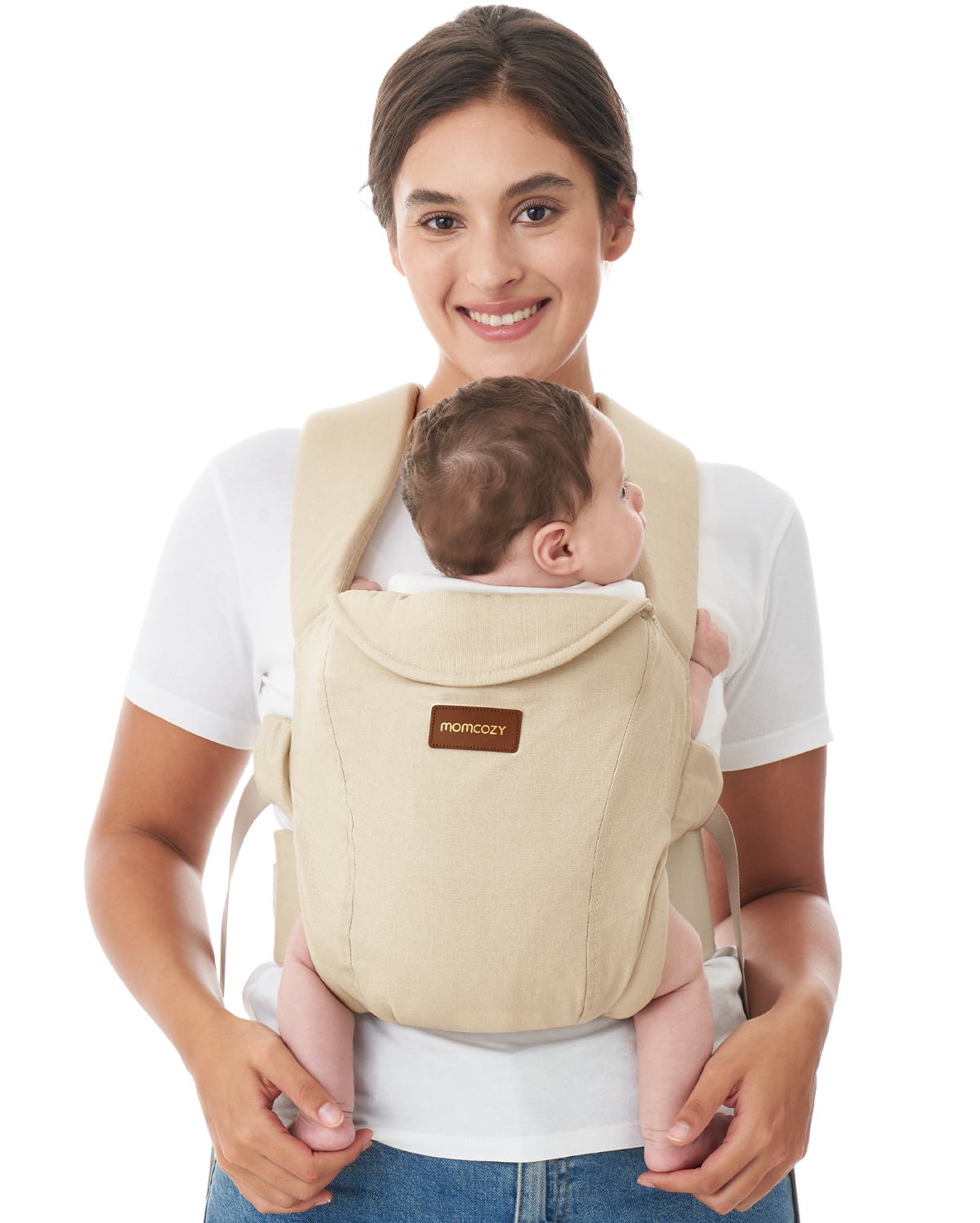Momcozy WeeSnug beige newborn carrier, baby held by smiling mother. Ergonomic design, comfortable baby carrier for newborns.
