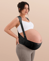 Pregnant woman wearing the oyster pink Momcozy maternity support band in a three-quarter view.